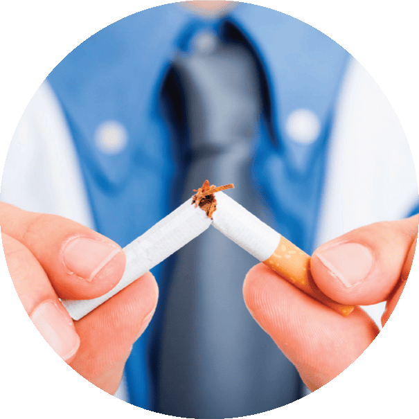 Person breaking a cigarette in half to symbolize quitting smoking